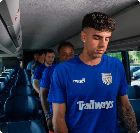 Players boarding a Trailways bus