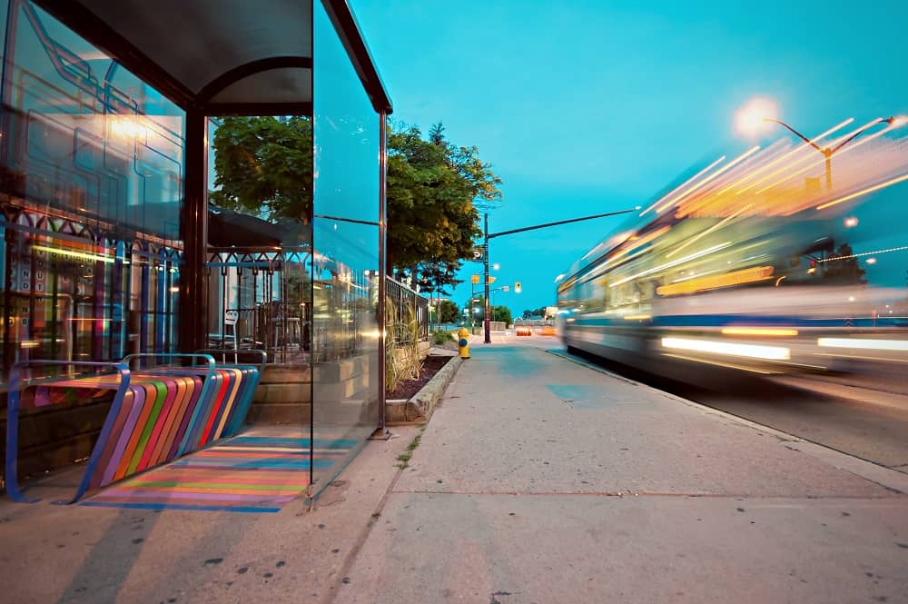 A train station in the evening with a fast-moving train going by